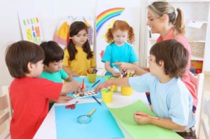 teacher with children painting